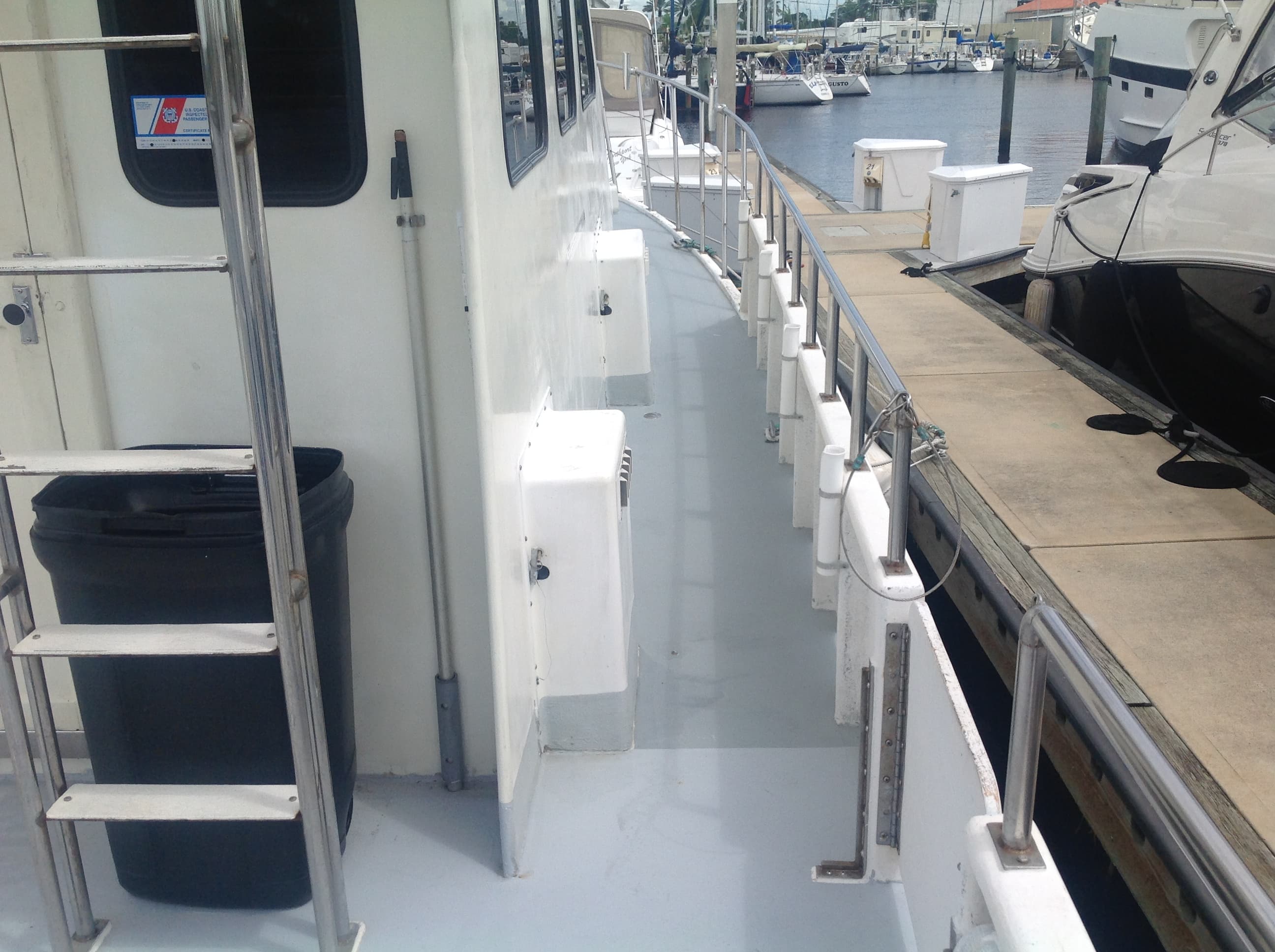 The rail along the boat's deck at the marina