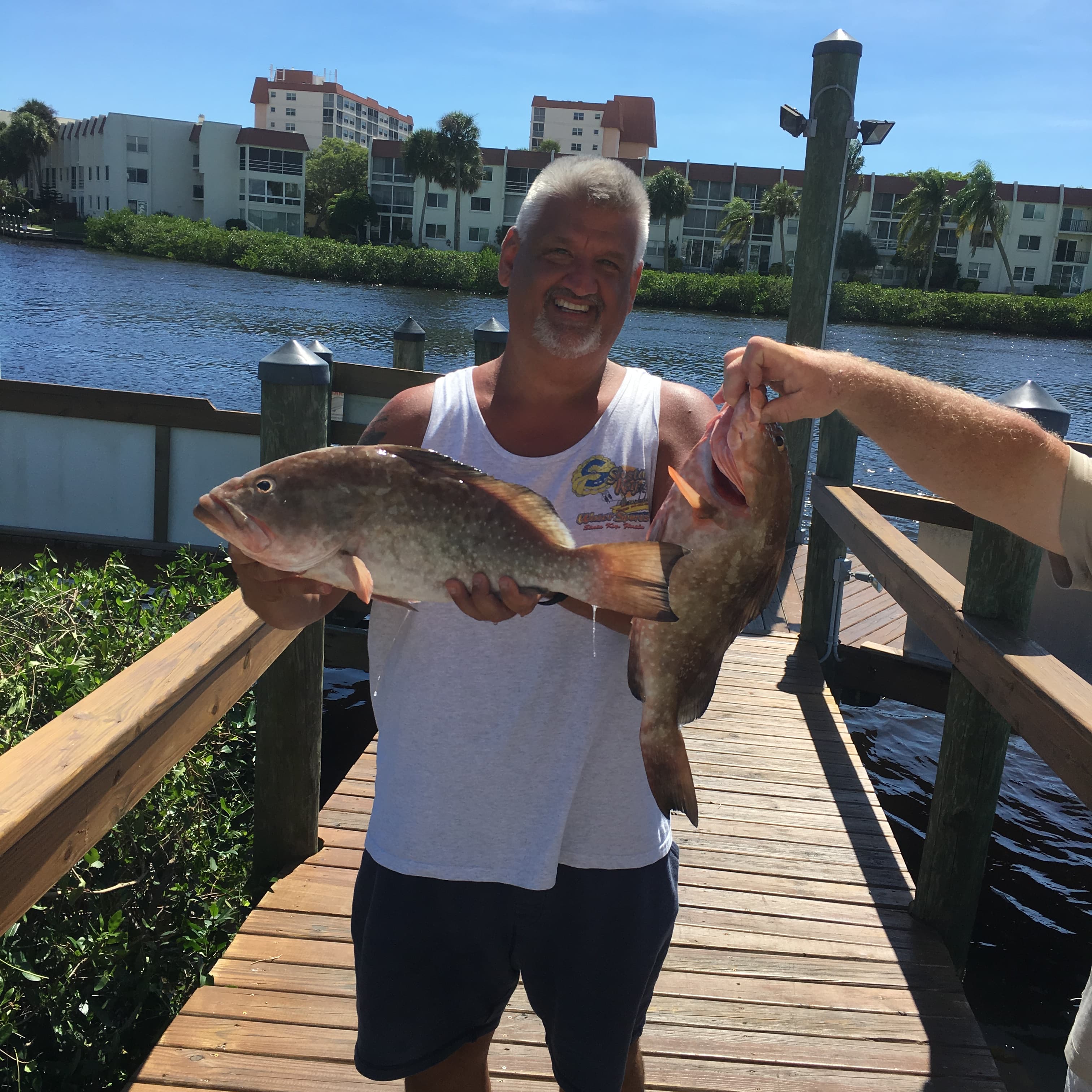 Captain aboard The Miss Venice Deep Sea Fishing with the day's grouper